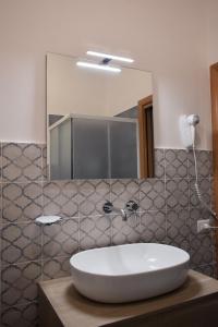 a bathroom with a sink and a mirror at A Casa Ru Mare in Castellammare del Golfo