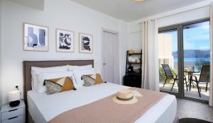 a bedroom with a bed with a hat on it at ALMYRA seafront residence in Lygia