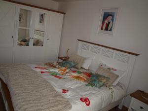 ein Bett mit Blumen darauf in einem Schlafzimmer in der Unterkunft Amavera Apartment in Târgu Jiu