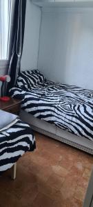 a zebra print bed in a room with a window at maison nathalia in Jávea