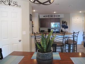 a kitchen and dining room with a table and a plant at Peaceful 1st floor lakeside condo minutes from Osage Beach and Ozark State Park in Kaiser