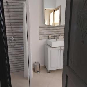 a bathroom with a sink and a mirror at Villa Michel in Tamraght Ouzdar +20 photos