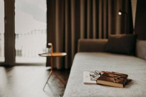 A bed or beds in a room at Hotel VIEW - incl Joker Card in Summer