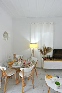 a dining room with a table and chairs at Olivo luxury apartment in Hydra
