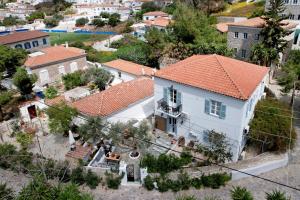 an overhead view of a white house with an orange roof at Olivo luxury apartment in Hydra