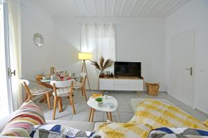 a living room with a couch and a table at Olivo Luxury Apartment in Hydra