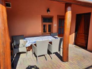 a dining table and chairs on a patio at Méz-Bor Szállás in Báránd