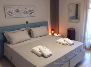 a bed with two towels on top of it at Villa Anna in Syvota