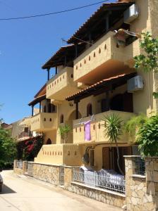a large building with a fence in front of it at Villa Anna in Syvota