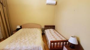 Postel nebo postele na pokoji v ubytování Guest House Lazika