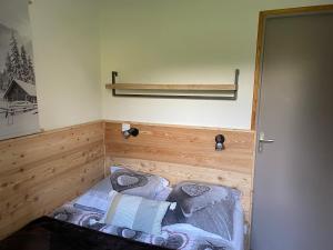 Un pequeño dormitorio con una cama en la esquina en Appartement rez de jardin expo sud en Saint-Gervais-les-Bains