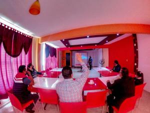 a group of people sitting at tables in a room at Hotel Villa De Las Flores in Zacatlán