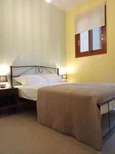 a bedroom with a large bed and a window at Marw's home in Nafplio