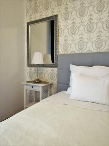 a bedroom with a white bed and a mirror at Accommodation Maria Di, Free Parking, Sea View in Dubrovnik