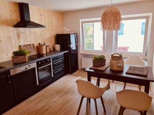 a kitchen with a table and chairs in a kitchen at Chalet in Ühlingen-Birkendorf