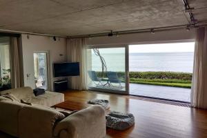 a living room with a view of the ocean at Beach Villa Varna - cosiness 4 meters from the sea in Varna City