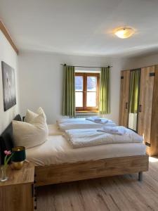 a bedroom with a large bed and a window at Der Limes Kipfenberg in Kipfenberg