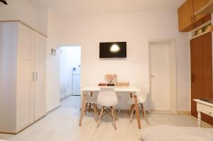 a kitchen with a table and chairs in a room at Old Town Experience - Studio Apartment in Budva