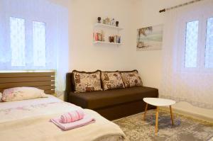 a bedroom with a bed and a couch at Old Town Experience - Studio Apartment in Budva