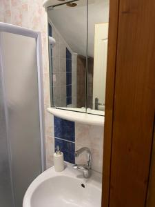 a bathroom with a sink and a mirror at Apartman studio Lusi 1 in Subotica