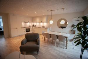 a kitchen and dining room with a table and chairs at New / 4 BR / Cozy / Walks / Hoyvík in Tórshavn
