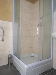 a shower with a glass door in a bathroom at Prenoćište Ljiljana 2 in Livno