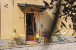 a door of a house with chairs and a table at Sun Garda in Ponti Sul Mincio