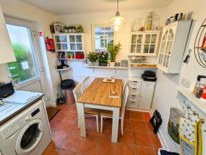 a kitchen with a table and a washing machine at 2 bedroom home in quiet location close to Chester in Hough Green