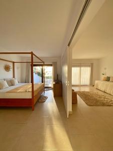 a bedroom with a canopy bed and a tile floor at Enjoy Jeri Praia in Jericoacoara