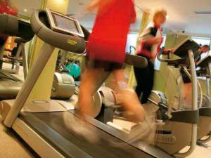 a woman running on a treadmill in a gym at Macdonald Bath Spa Hotel in Bath