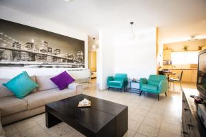 a living room with a couch and a table at Sunlight Holiday Apartment in Arad