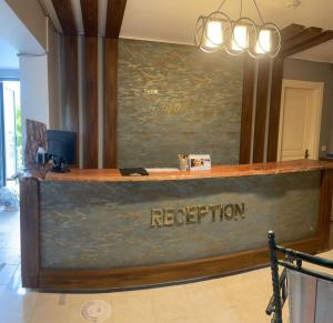 a reception counter in a room with a painting at Hotel Antonio in Çeşme