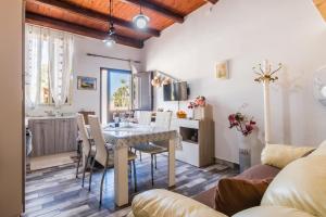 a kitchen and dining room with a table and chairs at "The Cottage"with sea view, parking & wifi in Avola +37 photos