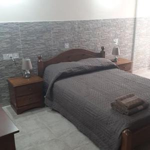 a bedroom with a large bed with two night stands at HAVEN HOUSE in Larnaca