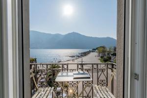 a balcony with a view of the water at Hotel Miralago in Cernobbio