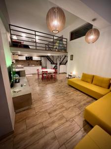 a living room with a yellow couch and a table at Apartman Cvjetni in Njivice +14 photos