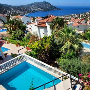 a villa with a swimming pool and a view of the ocean at Entire Villa Lulu Kalkan - Private Pool, free Wi-Fi, Good Location, Breathtaking Sea Views in Kalkan