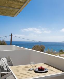 a table on a balcony with a view of the ocean at Sunray Lodgings in Kamari