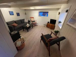 an overhead view of a living room with a couch and chairs at Lofoten_Beach_Eggum_Cabin in Eggum