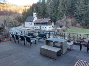 a patio with chairs and tables and a building at Large Family Holiday Home Siren Stays in Leoben
