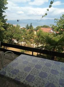 a table on a balcony with a view of the ocean at Apartments 64 in Star Dojran