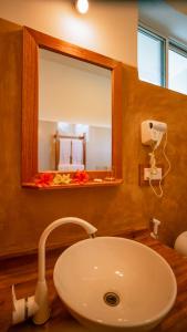 a bathroom with a sink and a mirror at Sansi Kendwa Beach Resort in Kendwa
