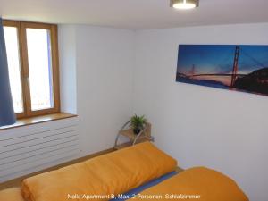 Ένα ή περισσότερα κρεβάτια σε δωμάτιο στο Nolla Apartment