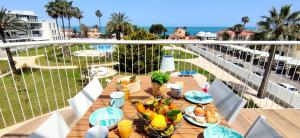 a table with food on top of a balcony at Apartamento Dénia Beach by DENIA COSTA in Denia