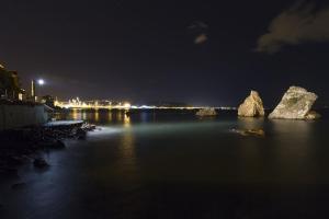 a view of a river at night with rocks in the water at ELISA Dependance Centro in Vietri sul Mare +7 photos