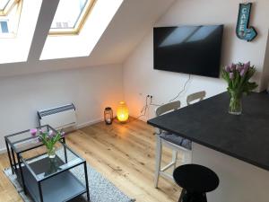a living room with a flat screen tv on the wall at Lendhafen in Klagenfurt