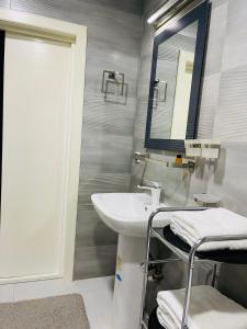 a bathroom with a sink and a mirror at Yas Apartment in Samarkand