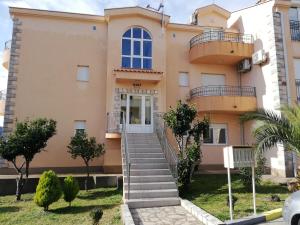 a house with stairs in front of it at Porto One Apartment in Đenovići