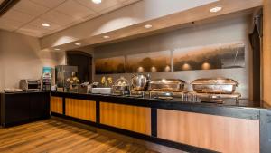 a kitchen with a counter with pots and pans at Best Western Plus of Birch Run/Frankenmuth in Birch Run
