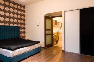 a bedroom with a bed and a sliding glass door at Apartament Ultracentral, Piata Romana in Bucharest